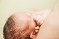 The Part of Face of Newborn Baby with Small Touching Hands. Royalty Free Stock Photo