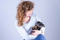 Part of a female, she lovingly holds a tiny sleeping Jack Russel Terrier puppy in her arms Royalty Free Stock Photo