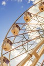 part of white ferris wheel against blue sky background. Vertical Royalty Free Stock Photo