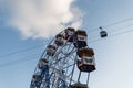 Part of a ferris wheel with colorful vintage cabins on a background of blue sky with clouds. Amusement park in Spain Royalty Free Stock Photo