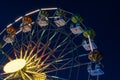 Part of a Ferris wheel at night with changing colors Royalty Free Stock Photo