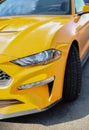 Part of front end of a yellow sport car, headlights and part of wheel. Close-up of the body of a yellow super sports car Royalty Free Stock Photo
