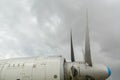 Part of the fuselage of the old military plane with the propeller closeup against the background of an empty and gray Royalty Free Stock Photo
