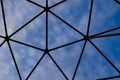 Part of geodesic dome construction with cloudy blue sky Royalty Free Stock Photo