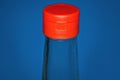 Part of glass bottle with soy sauce with closed  red plastic cap Royalty Free Stock Photo