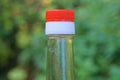 Part of glass bottle with soy sauce with closed white red plastic cap Royalty Free Stock Photo