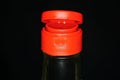 Part of glass bottle with soy sauce with red plastic cap Royalty Free Stock Photo