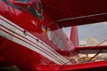 Part of the gleaming hull of a red UR ANC small passenger plane in sunset light. Exhibit of the National Museum of