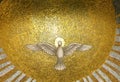 Part of a golden Mosaic inside a cuppola with The Holy Spirit representation as a white bird with open wings