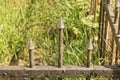 Part of a gray black small metal decorative fence with three sharp iron bars Royalty Free Stock Photo