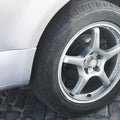 Part of the gray car. Car wheel