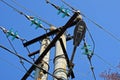 Part of a gray concrete pillar with electrical wires and a lamp against the blue sky Royalty Free Stock Photo