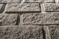 Part of gray concrete wall with masonry imitation. Royalty Free Stock Photo