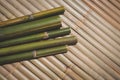 green bamboo trunks on wooden litter background