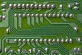 A part of a green printed circuit computer board with tracks. PCB without radio components. Old printed circuit board background Royalty Free Stock Photo