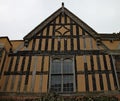 Part of a half timber framed building with ornate carvings on the facia boards