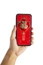 Chinese New Year 2020 Hand hold Ang Pao smart phone and white background.