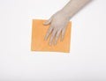 Part of the hand with an orange cloth for dusting and removing dirt. Cleaning, white background, free space for text.