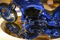 Part of Harley Davidson Blue Edition with front wheel, zylinder blocks, tank, seat blue and gold standing on mirror