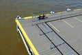 Part of the jetty with yellow marking and the metal fencing with handrails close to the waterside Royalty Free Stock Photo