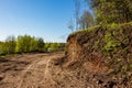 Part of the land cut off by an excavator to widen the passage