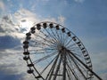 Part of large Ferris wheel against the background of summer daytime blue sky with clouds. Empty booths, no people. Attraction. Royalty Free Stock Photo