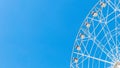 large ferris wheel on a background of a sky without clouds on a sunny day, copy space on blue Royalty Free Stock Photo