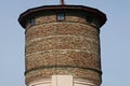 Large old brown brown water tower with windows on the sky background Royalty Free Stock Photo