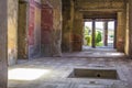 Part of the living room with frescoes painted on the walls in a ruined house in Pompeii, Naples, Italy. The ruins of the ancient c Royalty Free Stock Photo