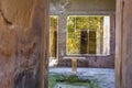 Part of the living room with frescoes painted on the walls in a ruined house in Pompeii, Naples, Italy. The ruins of the ancient c Royalty Free Stock Photo