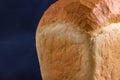 Part of a loaf of white bread on a blue background Royalty Free Stock Photo