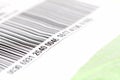 Part of a long barcode label sticker up close, number on a post package parcel, object detail, extreme closeup, shallow dof