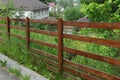 Part of a long rural fence of brown wooden planks outdoors Royalty Free Stock Photo