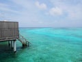 Part of Maldives water villa room in an island resort, seeing wood stairs down from balcony to ocean floor.