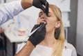 Stomatologist giving woman anesthesia in dentist`s clinic