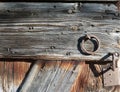 Part of a medieval barn door with wood grain and iron rings Royalty Free Stock Photo