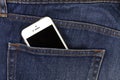 Part of mobile white cellphone in the back pocket of blue denim Royalty Free Stock Photo