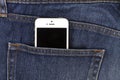 Part of mobile white cellphone in the back pocket of blue denim Royalty Free Stock Photo