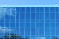 Part of modern building with blue windows with reflection Royalty Free Stock Photo