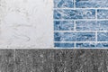 Part of modern building facade with dark black and white tiles texture and brick blue wall with abstract patterned background Royalty Free Stock Photo