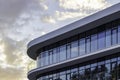 Part of a modern glass building on a background of blue sky. Royalty Free Stock Photo