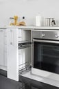 Part of modern kitchen with electric stove oven details and drawers Royalty Free Stock Photo