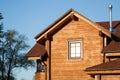 Part of modern wooden country house with blue sky on background. Roof of eco residential building near forest. Building Royalty Free Stock Photo