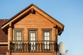 Part of modern wooden country house with blue sky on background. Roof of eco residential building near forest. Building Royalty Free Stock Photo