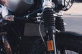 Part of a motorcycle on the street. Closeup shock absorber. Royalty Free Stock Photo