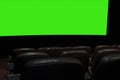 Part of a movie screen and rows of brown leather chairs in an empty cinema hall in a movie theater during quarantine coronavirus Royalty Free Stock Photo