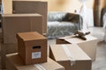 Part of new apartment with stacks of cardboard boxes standing in front of camera Royalty Free Stock Photo