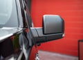 Part of the new black SUV car. Close-up rearview mirror. Exterior detail Royalty Free Stock Photo