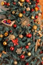 Part of the New Year green tree decorated with red toys, spheres, a star, gifts, snowflakes and gold thread of a garland