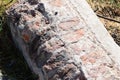 A piece of a fallen wall on the grass lies Royalty Free Stock Photo